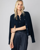 Woman wearing The Ainsley Sleeveless Cotton Polo in navy, layered styled view — State of Cotton NYC