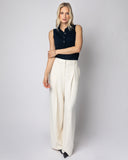 Woman wearing The Ainsley Sleeveless Cotton Polo in navy, styled — State of Cotton NYC