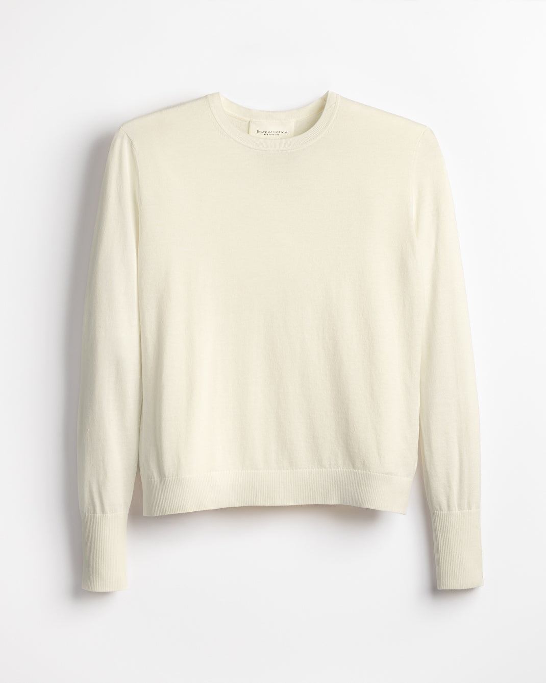 The Baldwin Superfine Cotton Sweater in cream, lifestyle view — State of Cotton NYC