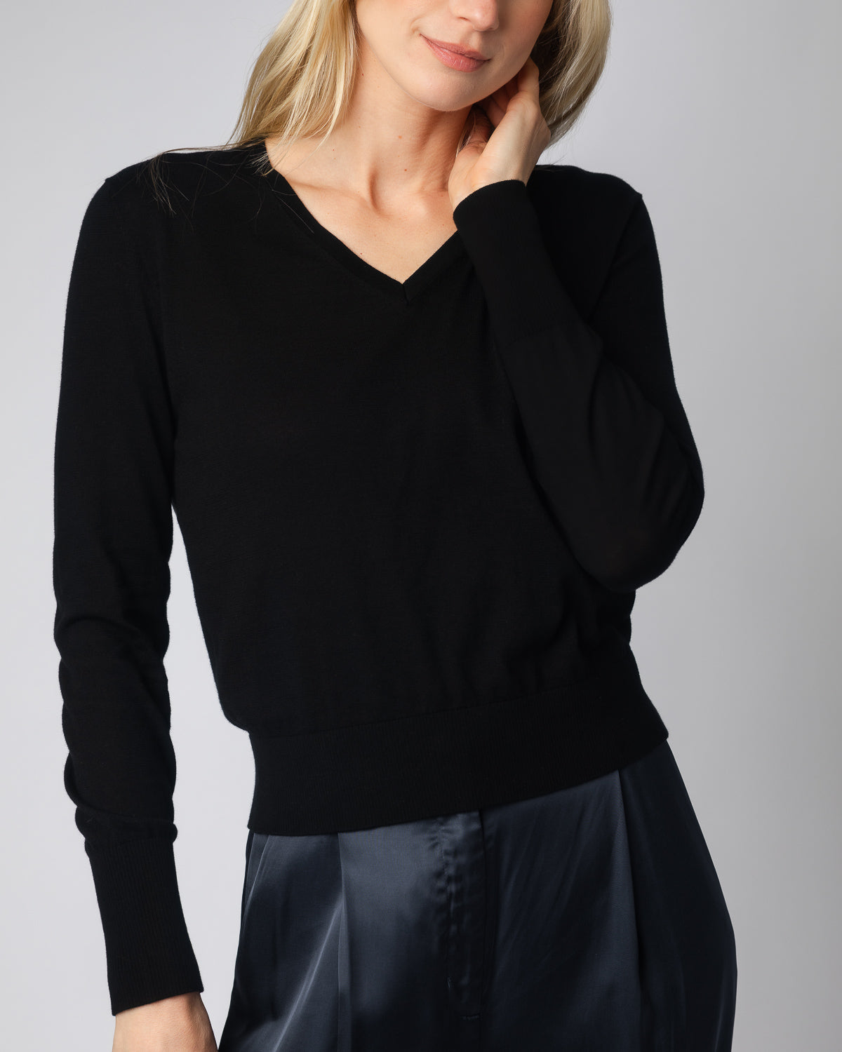 The Claremont Cotton V-Neck Sweater in black, styled view — State of Cotton NYC