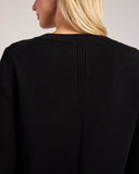 Detail shot of The Dorien V-Neck Cotton Sweater in black, neckline
