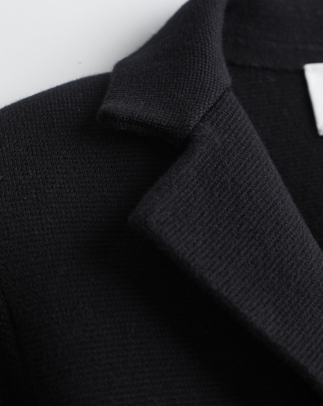 Detail shot of The Beale Cotton Cardigan Blazer in black — organic American cotton, Italian-spun