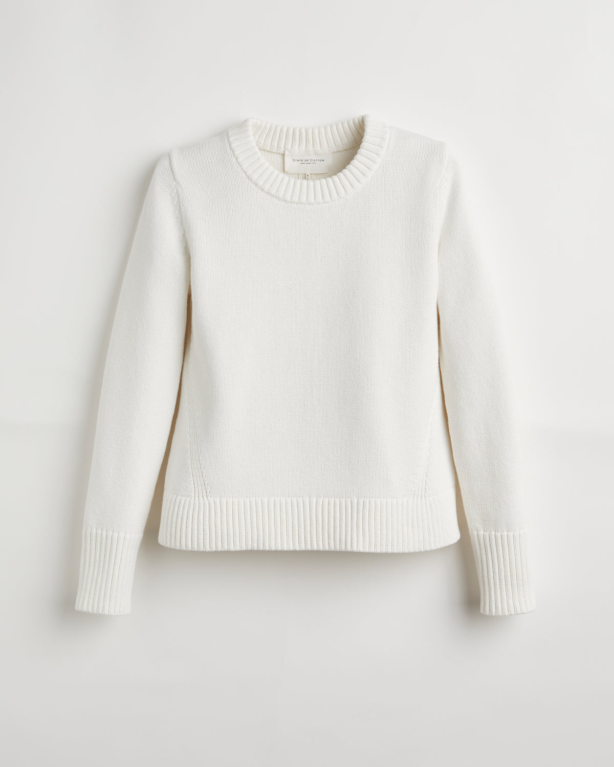 Woman wearing The Castine Cotton Crewneck Sweater in ivory — State of Cotton NYC