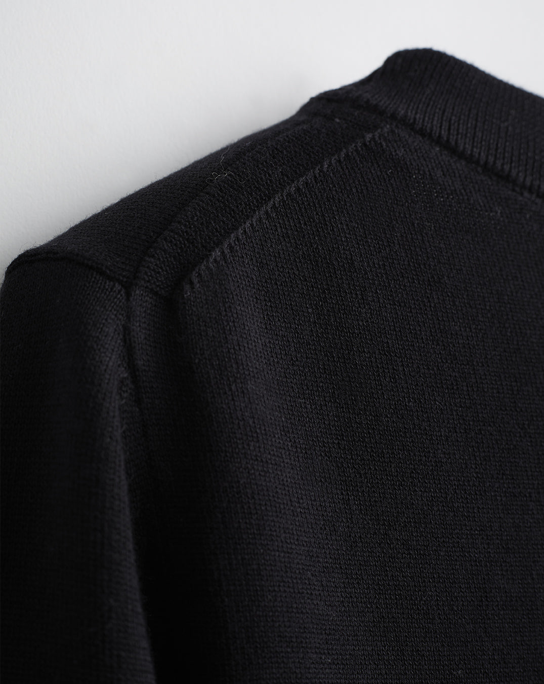 Detail shot of The Devon Cotton Crewneck Sweater in black — lightweight Egyptian cotton