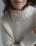 Detail shot of The Wynn Cotton Turtleneck Sweater in ivory, turtleneck collar — Turkish cotton