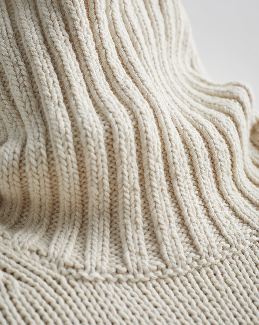 Detail shot of The Wynn Cotton Turtleneck Sweater in ivory — Turkish cotton